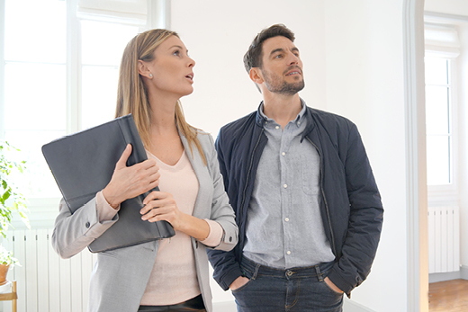 Besichtigung einer Immobilie mit Mann und Maklerin